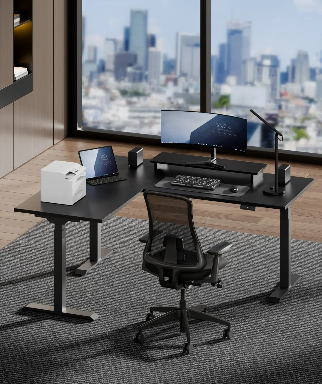 FlexiSpot E7L. Black E7L corner desk with curved monitor, printer, tablet and mesh chair in a high-rise office overlooking a city skyline; no text.